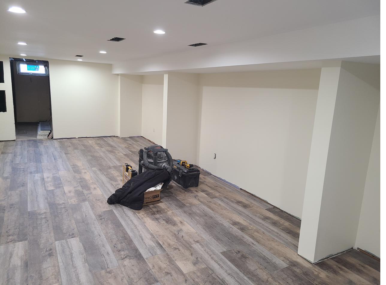 Finished basement with new flooring and drywall