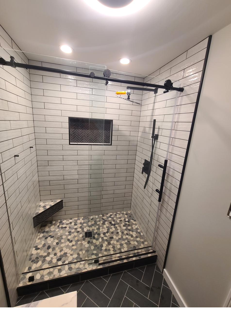 Finished custom tile shower with black hardware, installed by Smith Works Contracting