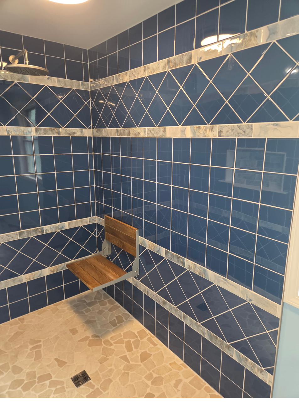 Detail shot of navy diamond-pattern tile and marble mosaic trim